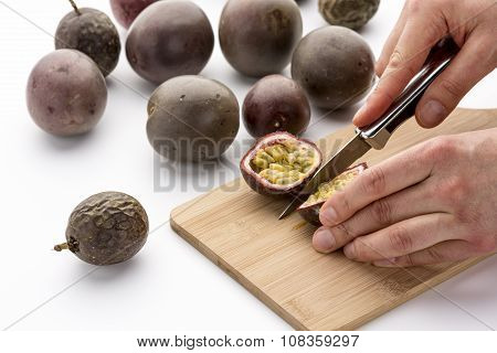 Knife Cutting A Passion Fruit Into Halves