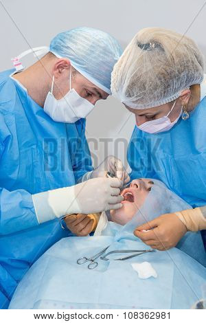 Dentists during surgery for implant placement