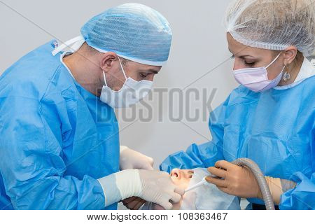 Dentists during surgery for implant placement