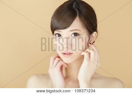 Beautiful asian woman isolated on beige background
