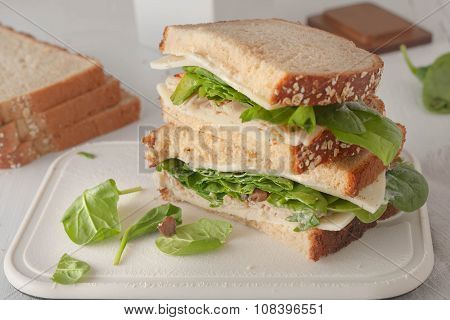 sandwich with mayonaisse, turkey, cheese and fresh spinach