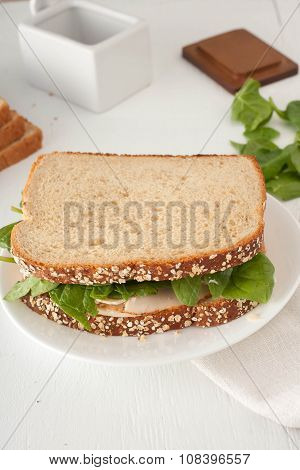 sandwich with mayonaisse, turkey, cheese and fresh spinach