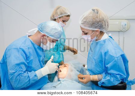 Dentists during surgery for implant placement