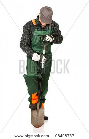 Smiling experienced gardener with a spade