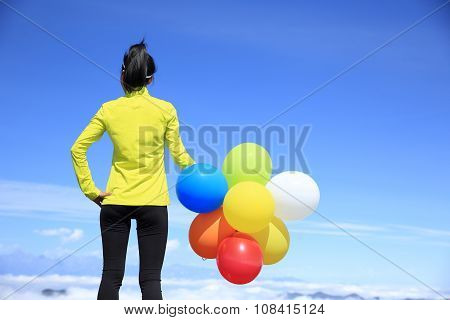 young woman with colorful balloons