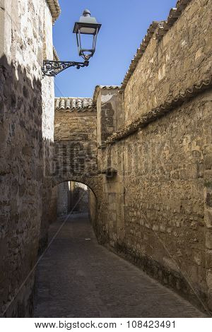 Medieval Neighborhood In Baeza, Alleyway With Stone Arch, Jaen Province, Andalusia, Spain