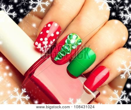 Christmas Nail art manicure. Winter Holiday style bright Manicure with gems Christmas tree and snowflakes. Bottle of Nail Polish. Beauty hands. Trendy Stylish Colorful Nails, Nailpolish