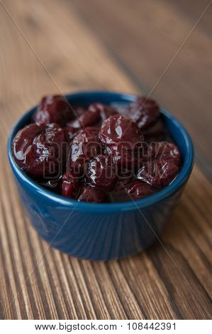 Canned cherries in a small blue piala