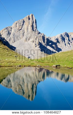 Ansabere Aiguilles reflected in Ansabere Lake. Lescun Cirque. Aspe Valley, Pyrenees, France.