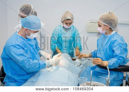 Dentists during surgery for implant placement