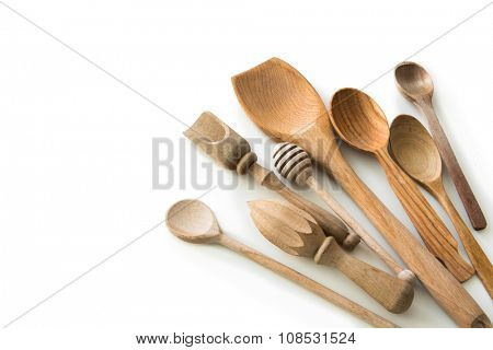 set of wooden kitchen spoons and other items on white background with textspace