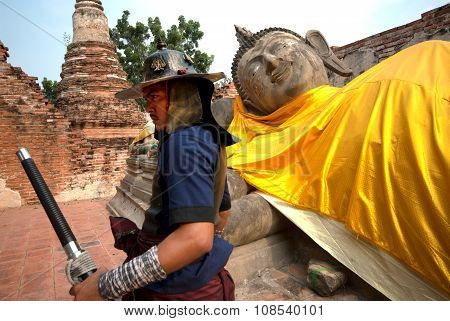 Ancient Warrior Posing Front Of Reclining Buddha.