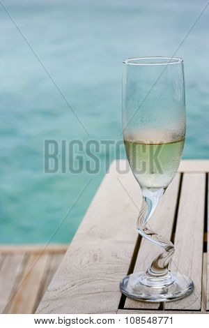 A Champagne Glasses By The Ocean
