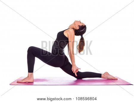 Beautiful woman doing Virabadrasana variant pose on yoga class. Studio shot.