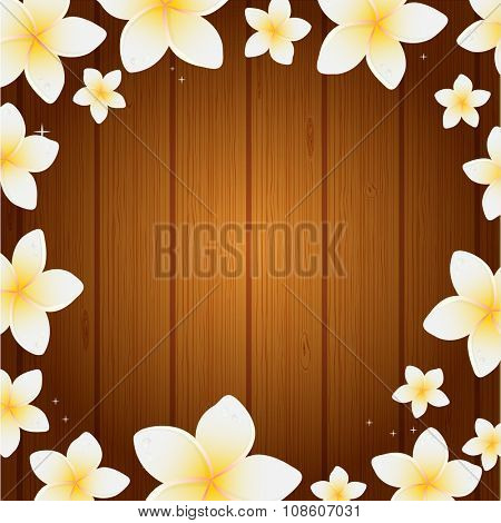 Spa background with frangipani flowers on wooden planks background. Background for web, spa, beauty salon an health center.