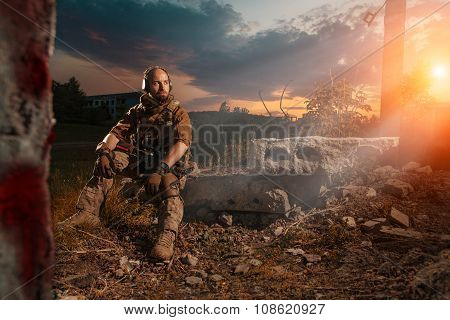 American Soldier With The M4 Rifle Is Having A Rest. Sunset On The Background.