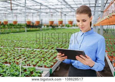 Pleasant greenhouse owner controlling her business
