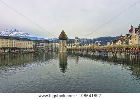 Famous wooden Chapel Bridge or Kapellbrucke in Lucerne Switzerland with its water tower seen in the middle. Subsequently restored the Kapellbrucke is the oldest wooden covered bridge in Europe