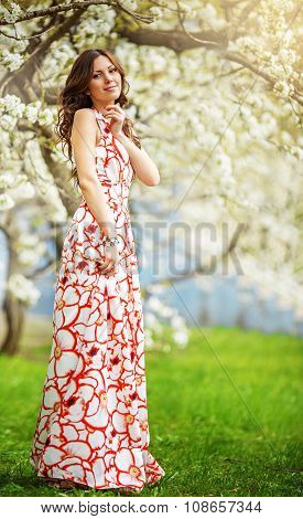 Beautiful young  brunette woman in spring garden