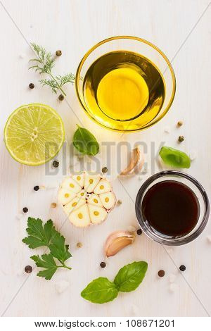 Ingrediets For Salad Dressing. Olive Oil, Garlic, Balsamic Vinegar, Lemon, Herbs And Spices