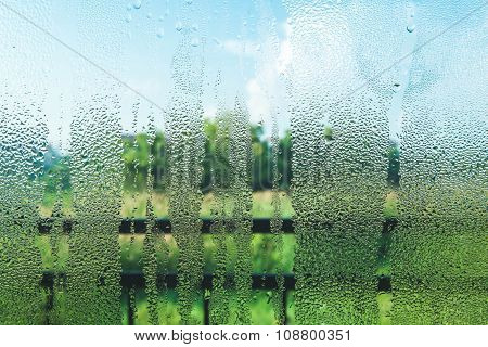 Droplets on glass in the morning with nature view
