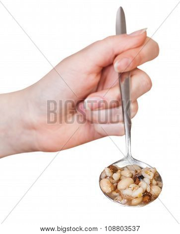 Female Hand Holds Spoon With Mess Of Pottage