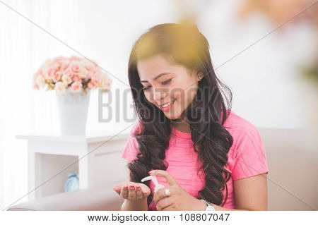 Woman Applying Lotion Into Her Skin