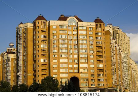 Kiev, Ukraine - July 15, 2015: Modern Multi-storey Orange Big House On Background Of Blue Sky