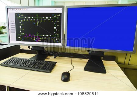 Computers and monitors with schematic diagram for supervisory, control and data acquisition