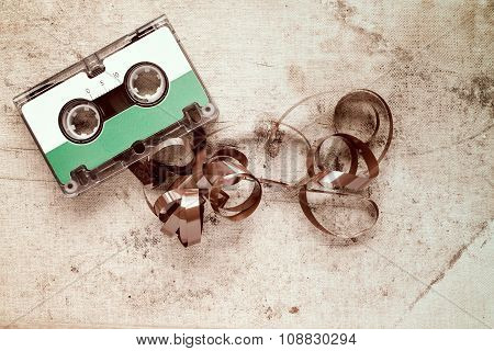 Cassette With Pulled Out Tape On Dirty Canvas