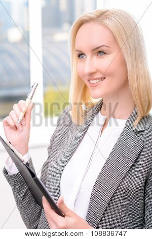 Confident businesswoman holding folder