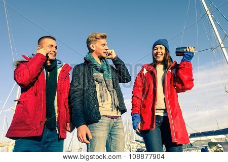 Sailing Trip Friends Having Fun Before Embark On Boat At Pier - Woman Holding Primitive Phone For Fu