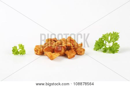 heap of pork greaves on white background