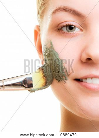 Skin Care. Woman Applying Clay Mud Mask On Face.