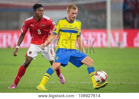 VIENNA, AUSTRIA - SEPTEMBER 9, 2014: David Alaba (#8 Austria) and Sebastian Larsson (#7 Sweden) fight for the ball in an European Championship qualifying game.