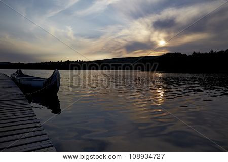 anada sunset lake with kayak and beautiful reflection
