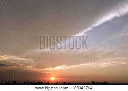 Evening sunset with cloudy skies and silhouette building scene