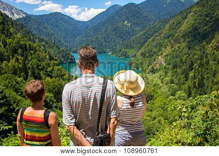 Tourists looking at mountain lake
