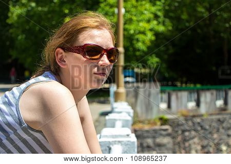 Young woman with sunglasses looking away