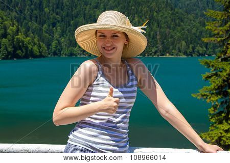 Happy young woman showing thumb