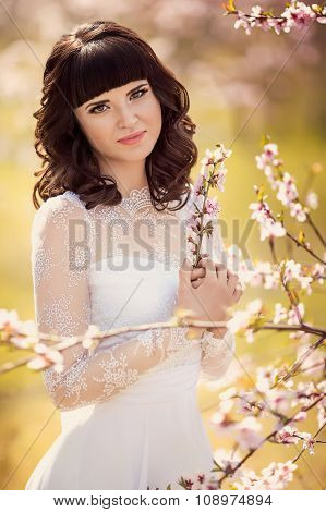 Beautiful bride with stylish make-up in white dress
