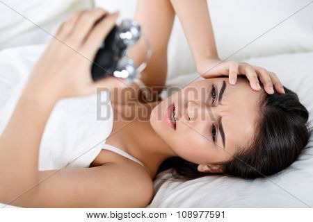 Pleasant girl lying in bed