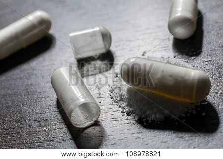 Macro Of 3 Closed And 1 Opened Medicine Capsules