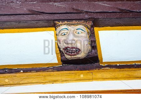 Wood Carving With Funny Faces On Timber Balk  Of Old Framework Houses