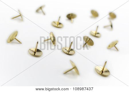 A Small Collection Of Thumbtacks In A White Box