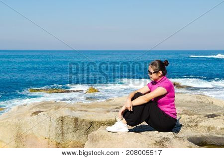 Asian girl explores the coastline of Bondi Beach in SydneyAustralia.