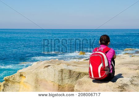 Young woman seen from behind oceanfront of bondi beach SydneyAustralia.