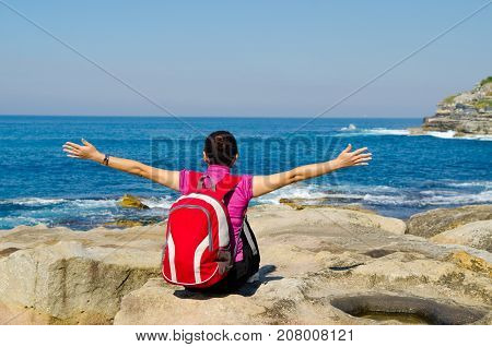 Young woman seen from behind oceanfront of bondi beach SydneyAustralia.
