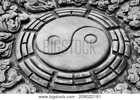 The stone carving of chinese yin yang symbol.