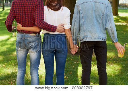Friendship love jealousy adultery polygamy concept. Love triangle. Young woman in relationship with two men.